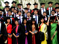 A group of graduates expressing their delight in front of the sculpture Raju at TSC area, on the 51th convocation of the students of Dhaka U...