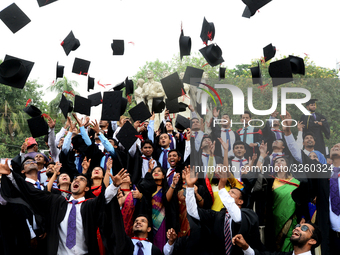 A group of graduates expressing their delight in front of the sculpture Raju at TSC area, on the 51th convocation of the students of Dhaka U...