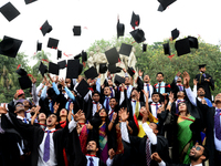 A group of graduates expressing their delight in front of the sculpture Raju at TSC area, on the 51th convocation of the students of Dhaka U...