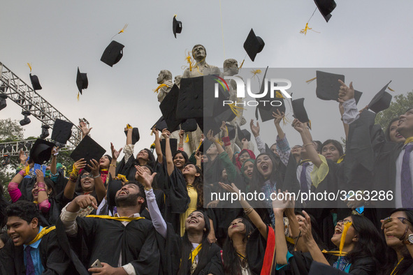 A group of graduates expressing their delight in front of the sculpture Raju at TSC area, on the 51th convocation of the students of Dhaka U...