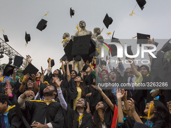 A group of graduates expressing their delight in front of the sculpture Raju at TSC area, on the 51th convocation of the students of Dhaka U...