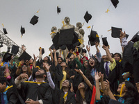 A group of graduates expressing their delight in front of the sculpture Raju at TSC area, on the 51th convocation of the students of Dhaka U...