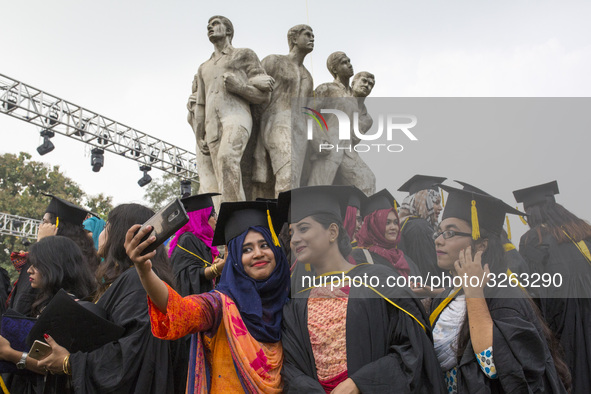 A group of graduates expressing their delight in front of the sculpture Raju at TSC area, on the 51th convocation of the students of Dhaka U...