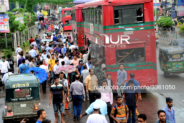 Bangladeshi Passengers gathers side the road to get on the public bus on the first day of 48-hour countrywide transport strike in Dhaka, Ban...