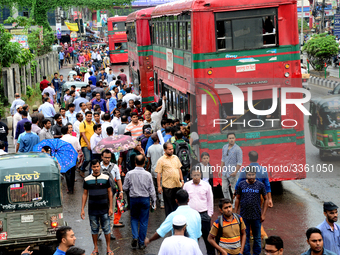 Bangladeshi Passengers gathers side the road to get on the public bus on the first day of 48-hour countrywide transport strike in Dhaka, Ban...