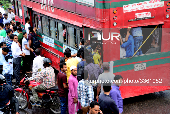 Bangladeshi Passengers gathers side the road to get on the public bus on the first day of 48-hour countrywide transport strike in Dhaka, Ban...