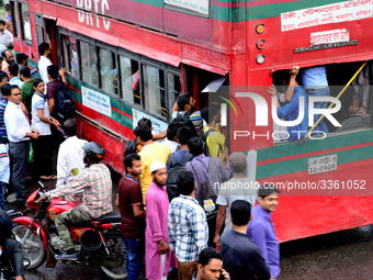 Bangladeshi Passengers gathers side the road to get on the public bus on the first day of 48-hour countrywide transport strike in Dhaka, Ban...