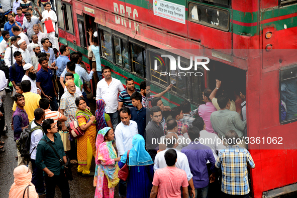 Bangladeshi Passengers gathers side the road to get on the public bus on the first day of 48-hour countrywide transport strike in Dhaka, Ban...