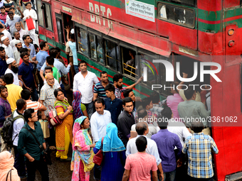 Bangladeshi Passengers gathers side the road to get on the public bus on the first day of 48-hour countrywide transport strike in Dhaka, Ban...