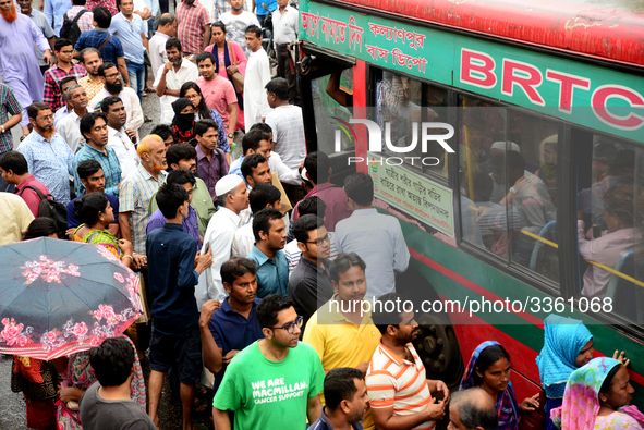 Bangladeshi Passengers gathers side the road to get on the public bus on the first day of 48-hour countrywide transport strike in Dhaka, Ban...