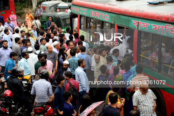 Bangladeshi Passengers gathers side the road to get on the public bus on the first day of 48-hour countrywide transport strike in Dhaka, Ban...