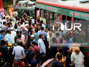 Bangladeshi Passengers gathers side the road to get on the public bus on the first day of 48-hour countrywide transport strike in Dhaka, Ban...