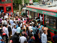 Bangladeshi Passengers gathers side the road to get on the public bus on the first day of 48-hour countrywide transport strike in Dhaka, Ban...