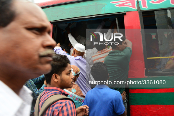 Bangladeshi Passengers gathers side the road to get on the public bus on the first day of 48-hour countrywide transport strike in Dhaka, Ban...