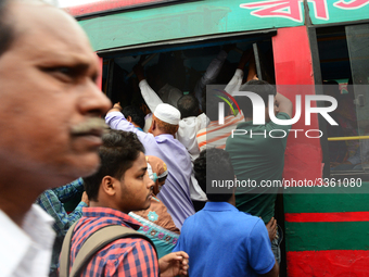 Bangladeshi Passengers gathers side the road to get on the public bus on the first day of 48-hour countrywide transport strike in Dhaka, Ban...