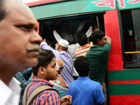 Bangladeshi Passengers gathers side the road to get on the public bus on the first day of 48-hour countrywide transport strike in Dhaka, Ban...