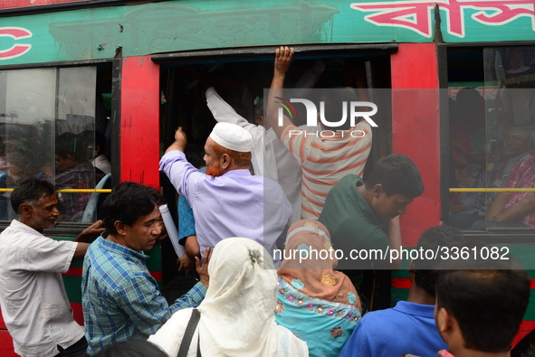 Bangladeshi Passengers gathers side the road to get on the public bus on the first day of 48-hour countrywide transport strike in Dhaka, Ban...