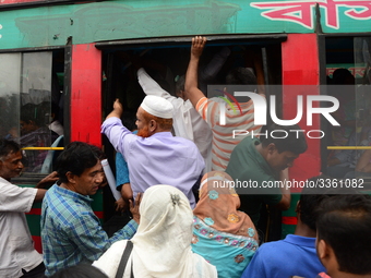 Bangladeshi Passengers gathers side the road to get on the public bus on the first day of 48-hour countrywide transport strike in Dhaka, Ban...