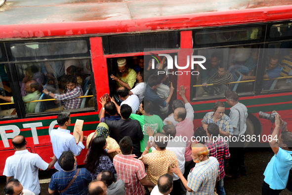 Bangladeshi Passengers gathers side the road to get on the public bus on the first day of 48-hour countrywide transport strike in Dhaka, Ban...