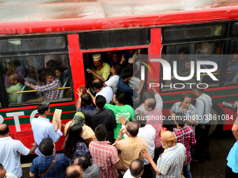 Bangladeshi Passengers gathers side the road to get on the public bus on the first day of 48-hour countrywide transport strike in Dhaka, Ban...