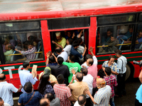 Bangladeshi Passengers gathers side the road to get on the public bus on the first day of 48-hour countrywide transport strike in Dhaka, Ban...