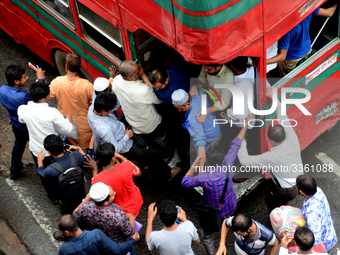 Bangladeshi Passengers gathers side the road to get on the public bus on the first day of 48-hour countrywide transport strike in Dhaka, Ban...