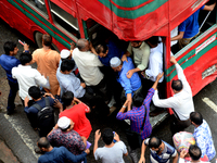 Bangladeshi Passengers gathers side the road to get on the public bus on the first day of 48-hour countrywide transport strike in Dhaka, Ban...