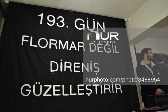 A man stands next to a banner during a solidarity event in support of Flormar's workers in Ankara, Turkey on November 23, 2018. The resistan...