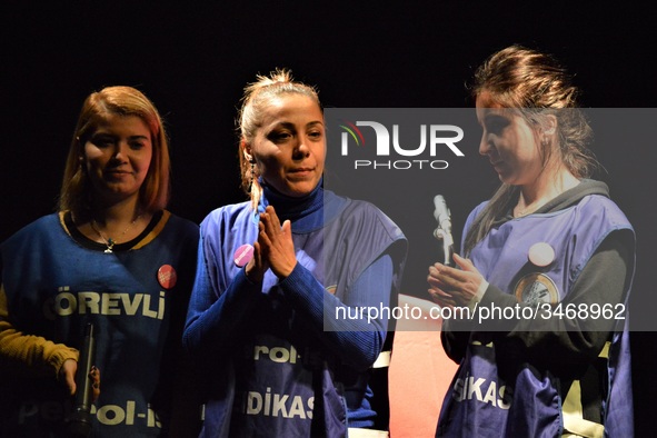 Flormar's laid-off workers Ayse Ozturk (C) and her colleagues stand on the stage during a solidarity event in support of Flormar's workers i...