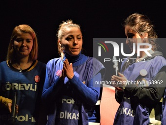 Flormar's laid-off workers Ayse Ozturk (C) and her colleagues stand on the stage during a solidarity event in support of Flormar's workers i...