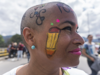 A woman with drawings alluding to education participates in the march of students for public education in Bogota, Colombia, on 28 November 2...