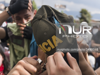 People who participate in the march of students for public education in Bogota, Colombia, on 28 November 2018. burn a cap of a police office...