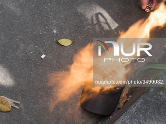 People who participate in the march of students for public education in Bogota, Colombia, on 28 November 2018. burn a cap of a police office...