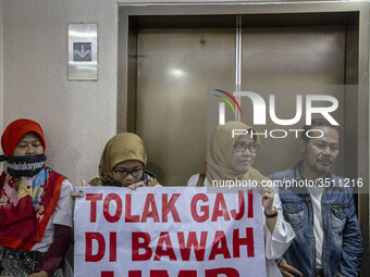 Jakarta, Indonesia, 04 December 2018 : Employee of Antara news Agency that were paid under minimum wage with banner said "Stop Paying under...