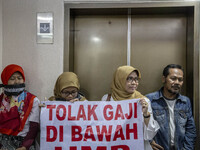 Jakarta, Indonesia, 04 December 2018 : Employee of Antara news Agency that were paid under minimum wage with banner said "Stop Paying under...