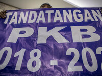 Jakarta, Indonesia, 04 December 2018 : Employee with poster that demanding the agreement of Employee and company. hundreds of Indonesian New...