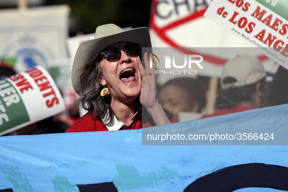 Teachers and supporters of public education march against education funding cuts during the March for Public Education in Los Angeles, Calif...