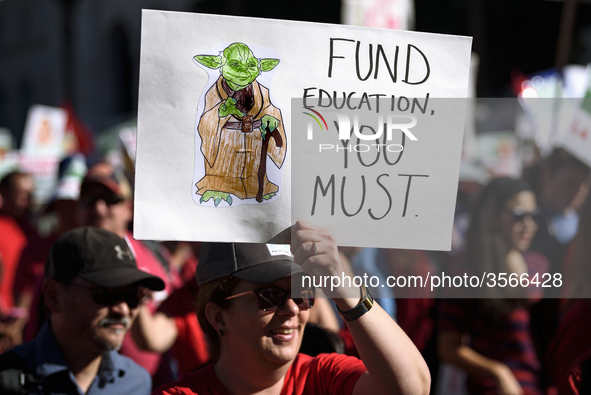 Teachers and supporters of public education march against education funding cuts during the March for Public Education in Los Angeles, Calif...