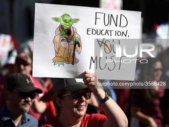 Teachers and supporters of public education march against education funding cuts during the March for Public Education in Los Angeles, Calif...