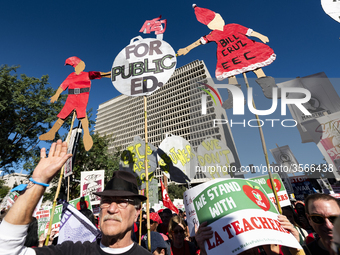 Teachers and supporters of public education march against education funding cuts during the March for Public Education in Los Angeles, Calif...