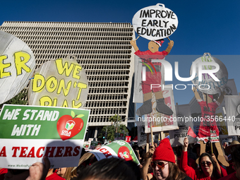 Teachers and supporters of public education march against education funding cuts during the March for Public Education in Los Angeles, Calif...