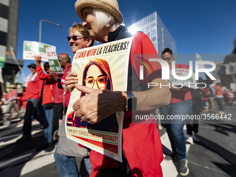 Teachers and supporters of public education march against education funding cuts during the March for Public Education in Los Angeles, Calif...