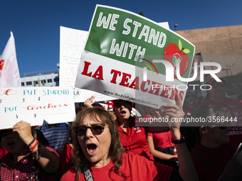 Teachers and supporters of public education march against education funding cuts during the March for Public Education in Los Angeles, Calif...