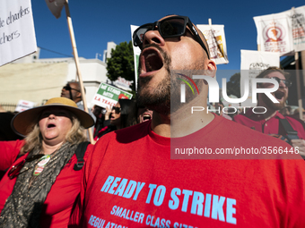 Teachers and supporters of public education march against education funding cuts during the March for Public Education in Los Angeles, Calif...