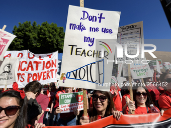 Teachers and supporters of public education march against education funding cuts during the March for Public Education in Los Angeles, Calif...