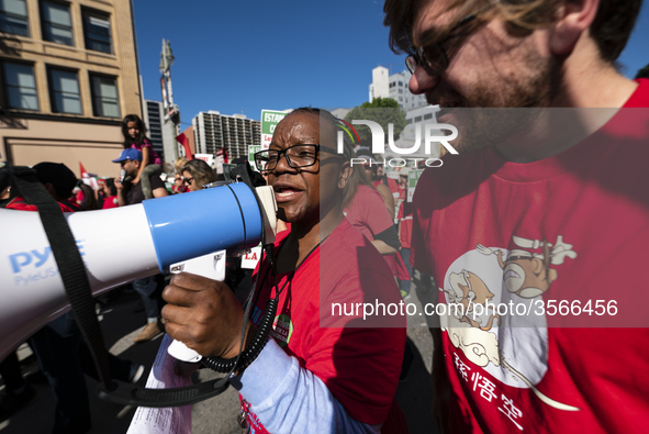 Teachers and supporters of public education march against education funding cuts during the March for Public Education in Los Angeles, Calif...