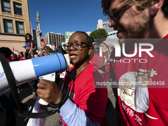 Teachers and supporters of public education march against education funding cuts during the March for Public Education in Los Angeles, Calif...