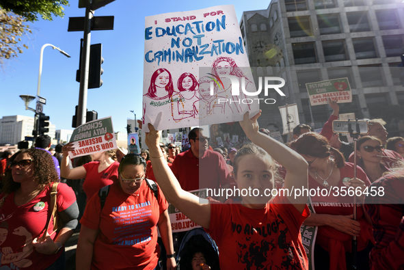 Teachers and supporters of public education march against education funding cuts during the March for Public Education in Los Angeles, Calif...