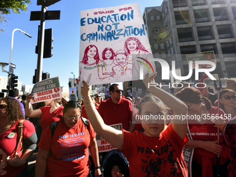 Teachers and supporters of public education march against education funding cuts during the March for Public Education in Los Angeles, Calif...