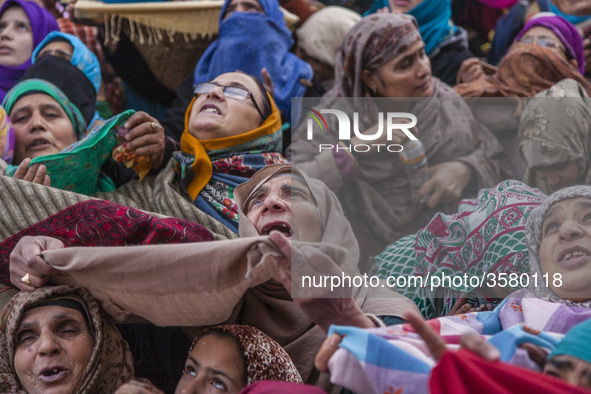 Kashmiri Muslim women devotees look towards a cleric (not seen in the picture) displaying the holy relic believed to be the whisker from the...